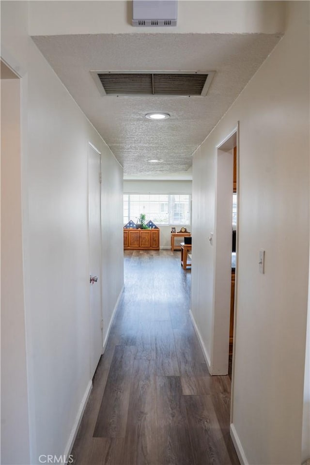 10515 Acoro St, Bellflower, CA 90706 - hall with dark wood-style floors and a textured ceiling