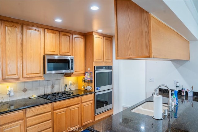 10515 Acoro St, Bellflower, CA 90706 - kitchen with appliances with stainless steel finishes, dark stone counters, backsplash, and recessed lighting