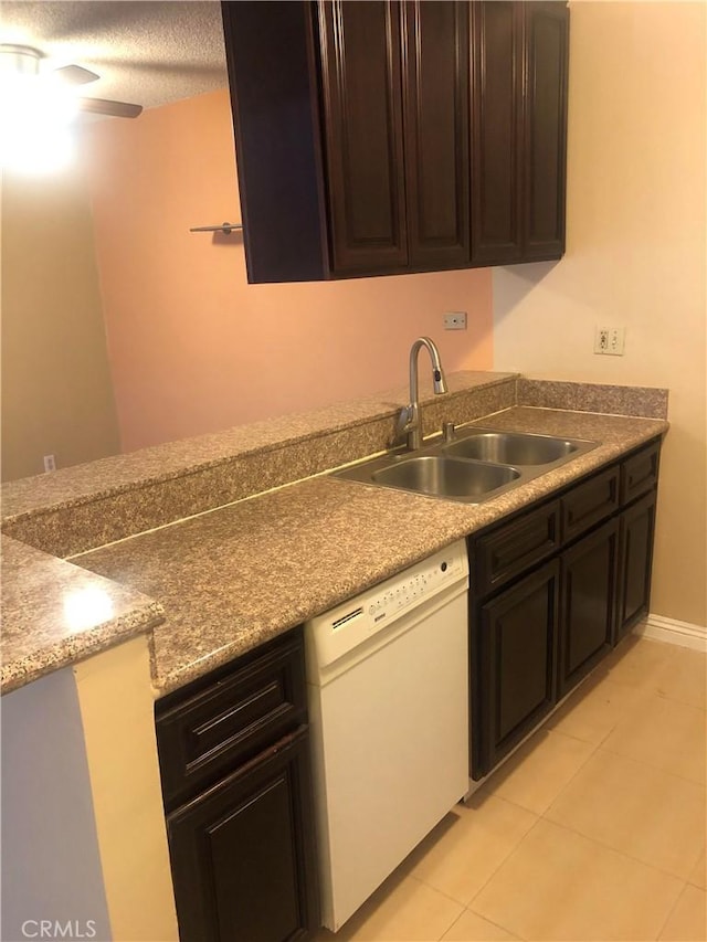 8601 International Ave Unit 236, Canoga Park, CA 91304 - kitchen with white dishwasher, light tile patterned floors, and dark brown cabinetry