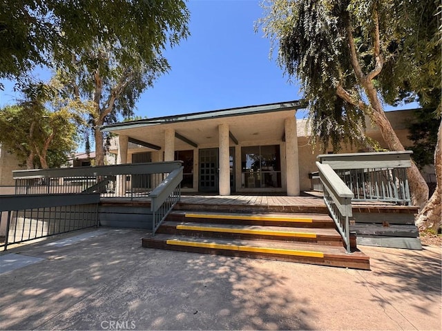 8601 International Ave Unit 236, Canoga Park, CA 91304 - property entrance with a deck, stucco siding, and a patio