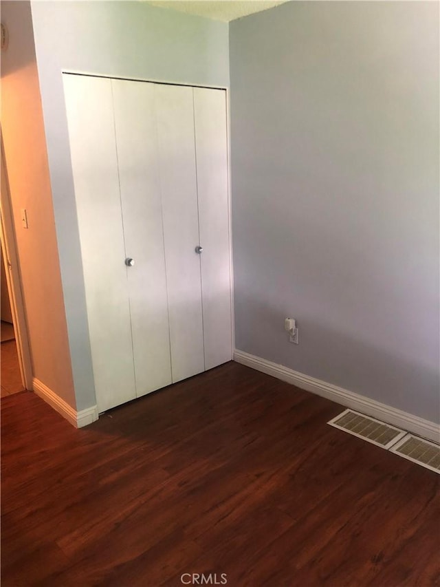 8601 International Ave Unit 236, Canoga Park, CA 91304 - unfurnished bedroom with dark wood-style flooring and a closet