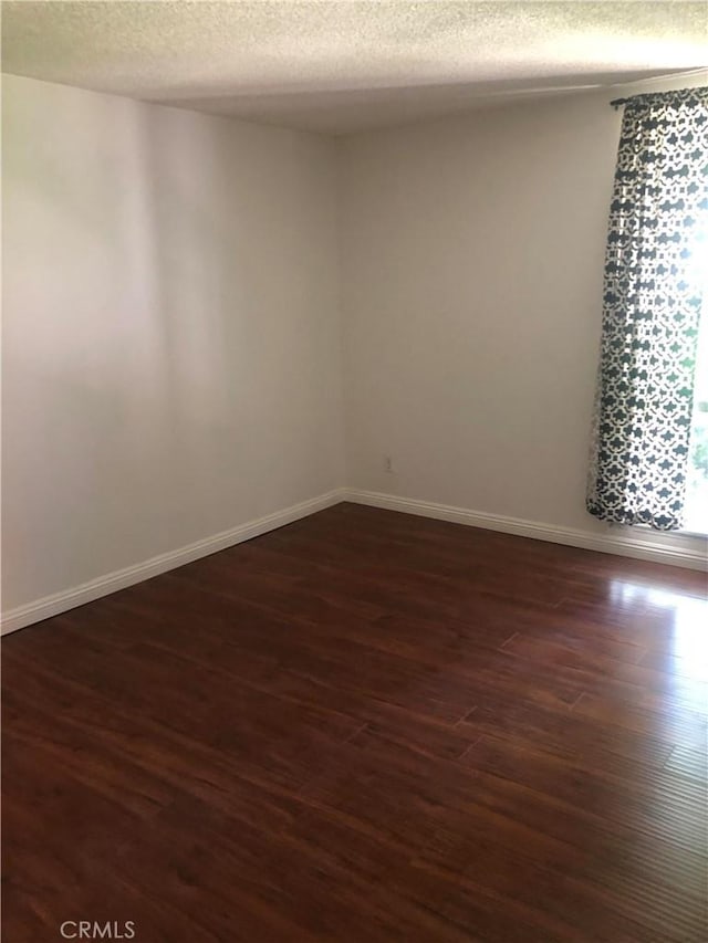 8601 International Ave Unit 236, Canoga Park, CA 91304 - empty room with a textured ceiling and dark wood finished floors