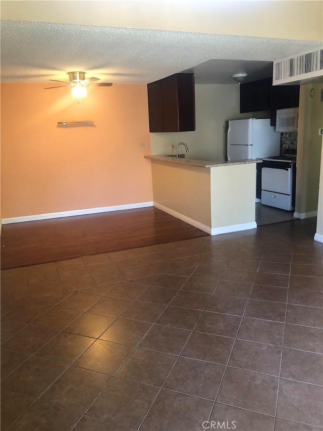 8601 International Ave Unit 236, Canoga Park, CA 91304 - kitchen with white appliances, a textured ceiling, a peninsula, and a ceiling fan
