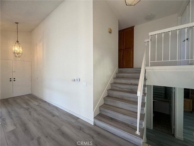 22608 Ironbark Dr, Diamond Bar, CA 91765 - staircase with wood finished floors and a chandelier