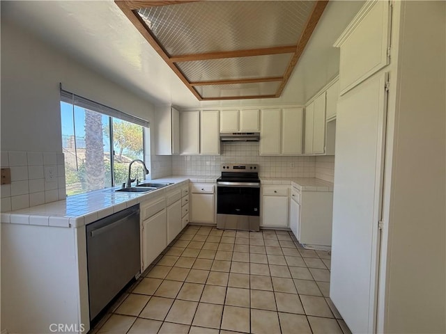 22608 Ironbark Dr, Diamond Bar, CA 91765 - kitchen with appliances with stainless steel finishes, under cabinet range hood, tasteful backsplash, tile counters, and light tile patterned flooring