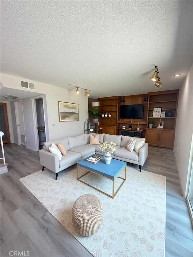 22608 Ironbark Dr, Diamond Bar, CA 91765 - living area with a textured ceiling and light wood finished floors