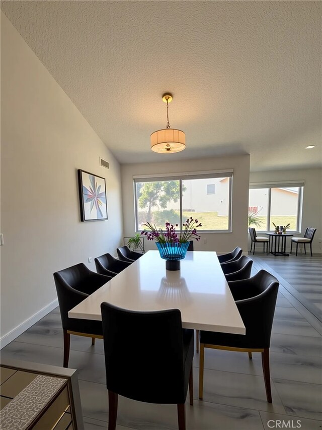 22608 Ironbark Dr, Diamond Bar, CA 91765 - dining space featuring a textured ceiling, healthy amount of natural light, and wood finished floors