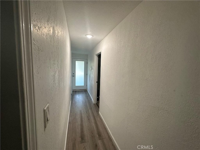 2023 Jewell Ln, Redding, CA 96001 - hallway featuring a textured wall and dark wood-style flooring