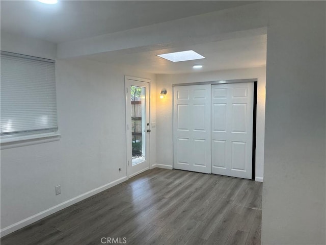2023 Jewell Ln, Redding, CA 96001 - unfurnished bedroom featuring a skylight, wood finished floors, and a closet