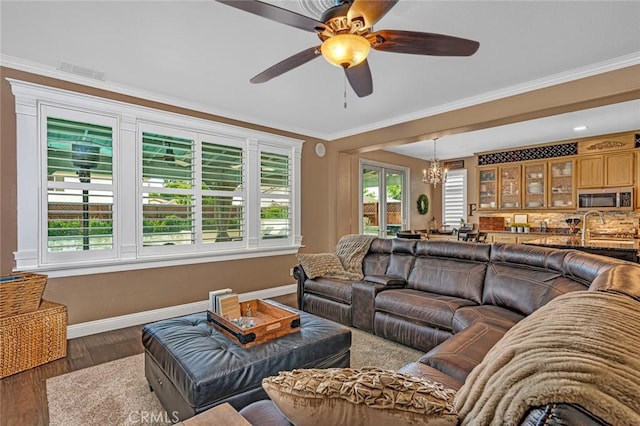 4139 Sunshine Ct, Merced, CA 95340 - living room with a chandelier, a ceiling fan, wood finished floors, and ornamental molding