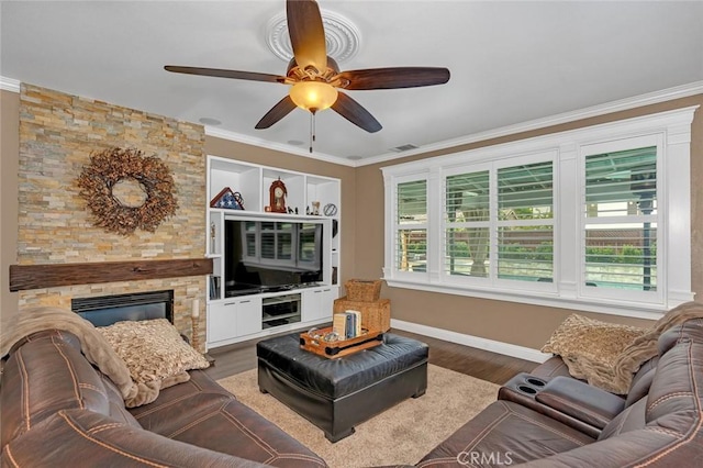 4139 Sunshine Ct, Merced, CA 95340 - living room featuring healthy amount of natural light, a ceiling fan, wood finished floors, crown molding, and a stone fireplace