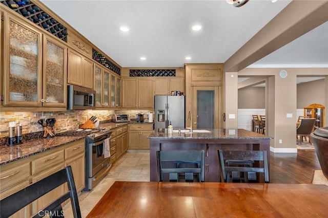 4139 Sunshine Ct, Merced, CA 95340 - kitchen featuring stainless steel appliances, decorative backsplash, ornamental molding, dark stone countertops, and glass insert cabinets