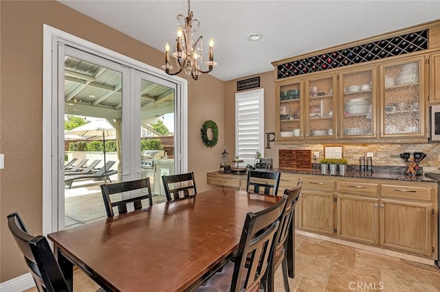 4139 Sunshine Ct, Merced, CA 95340 - dining area featuring a chandelier and light stone finish floors