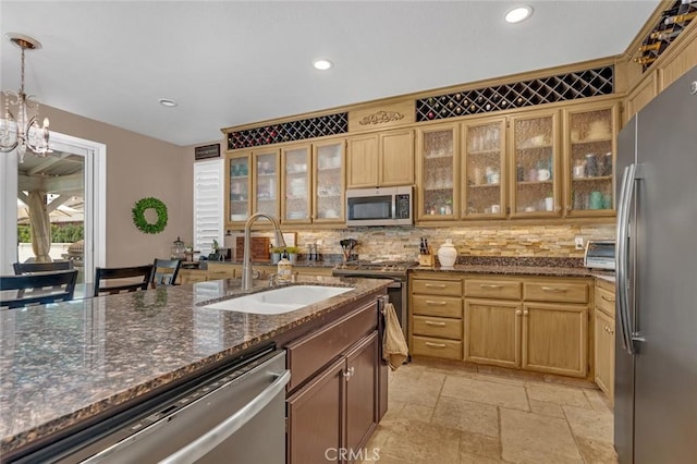 4139 Sunshine Ct, Merced, CA 95340 - kitchen featuring appliances with stainless steel finishes, stone tile flooring, tasteful backsplash, recessed lighting, and decorative light fixtures