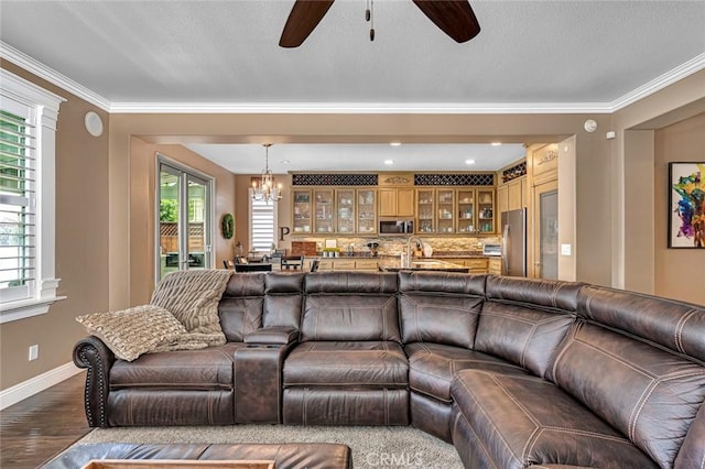 4139 Sunshine Ct, Merced, CA 95340 - living area with a chandelier, ceiling fan, dark wood finished floors, healthy amount of natural light, and ornamental molding