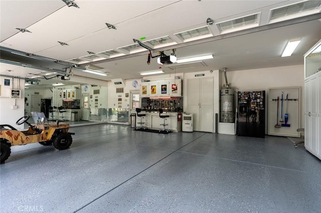 4139 Sunshine Ct, Merced, CA 95340 - garage with strapped water heater and a garage door opener