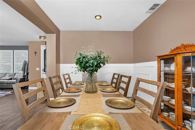 4139 Sunshine Ct, Merced, CA 95340 - dining space featuring wood finished floors, a wainscoted wall, and a decorative wall