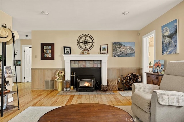 1 Sunny Slope, Running Springs, CA 92382 - living room featuring light wood-style flooring, wainscoting, and a fireplace