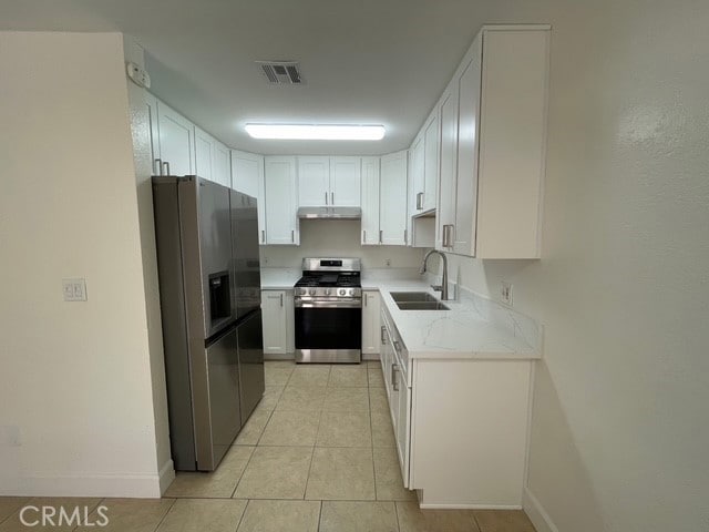 1415 El Sereno Ave Unit 4, Pasadena, CA 91103 - kitchen featuring appliances with stainless steel finishes, under cabinet range hood, white cabinets, and light tile patterned floors