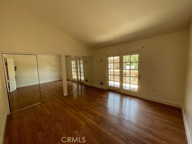 1415 El Sereno Ave Unit 4, Pasadena, CA 91103 - unfurnished bedroom featuring multiple windows, wood finished floors, and high vaulted ceiling
