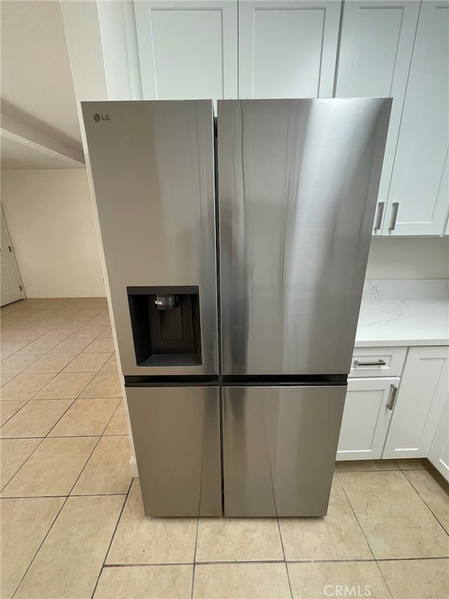 1415 El Sereno Ave Unit 4, Pasadena, CA 91103 - kitchen with stainless steel fridge, light tile patterned floors, and white cabinetry