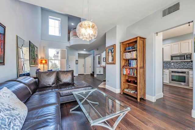 6847 Adolphia Dr, Carlsbad, CA 92011 - living area with a chandelier, dark wood-style floors, and a high ceiling