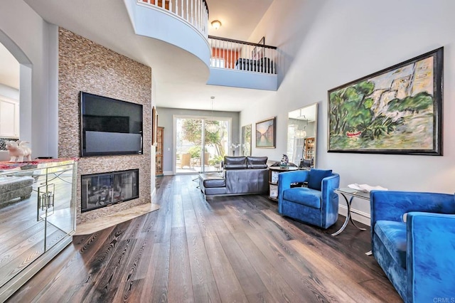 6847 Adolphia Dr, Carlsbad, CA 92011 - living room with wood finished floors, a fireplace, arched walkways, and a high ceiling