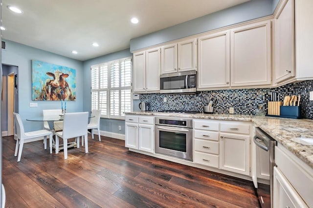 6847 Adolphia Dr, Carlsbad, CA 92011 - kitchen with appliances with stainless steel finishes, tasteful backsplash, dark wood-type flooring, recessed lighting, and light stone counters