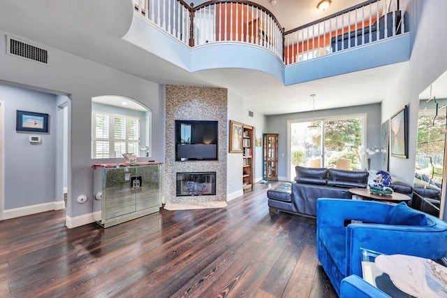 6847 Adolphia Dr, Carlsbad, CA 92011 - living area featuring wood finished floors, healthy amount of natural light, a high ceiling, and a fireplace