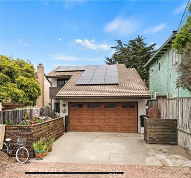 1246 15th St, Los Osos, CA 93402 - view of front of home with a tiled roof, solar panels, stucco siding, and a chimney