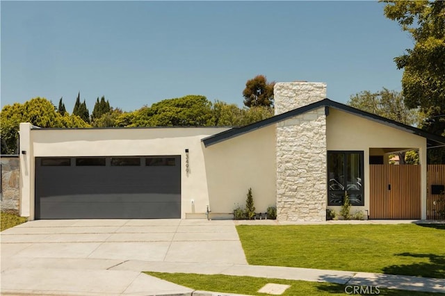 3499 San Rafael Cir, Costa Mesa, CA 92626 - contemporary house with stucco siding, stone siding, driveway, a front lawn, and a garage