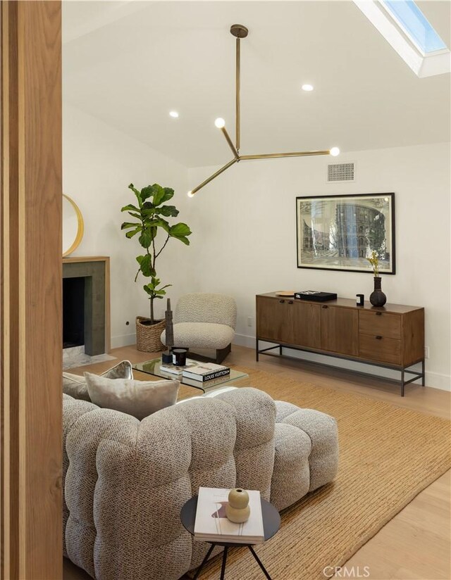 3499 San Rafael Cir, Costa Mesa, CA 92626 - living room with a skylight, wood finished floors, recessed lighting, and vaulted ceiling