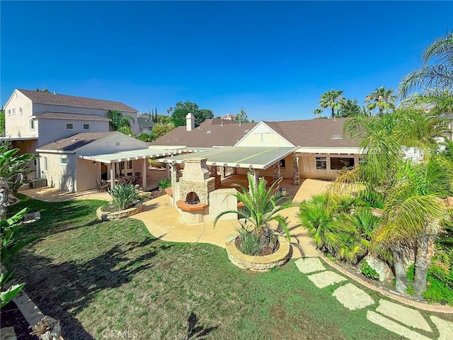 43097 Calle Camellia, Temecula, CA 92592 - rear view of property featuring a patio, an outdoor stone fireplace, a chimney, and a lawn