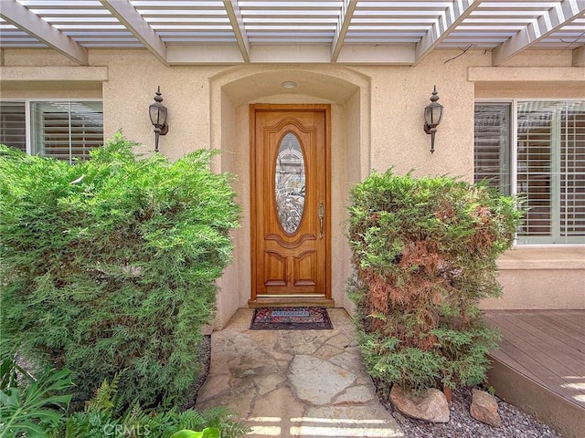 43097 Calle Camellia, Temecula, CA 92592 - property entrance with stucco siding, a pergola, and a wooden deck