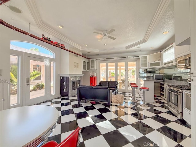 43097 Calle Camellia, Temecula, CA 92592 - living room featuring a tray ceiling, french doors, ornamental molding, plenty of natural light, and a ceiling fan