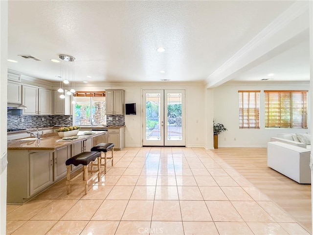 43097 Calle Camellia, Temecula, CA 92592 - kitchen featuring crown molding, open floor plan, decorative backsplash, a breakfast bar area, and light tile patterned flooring