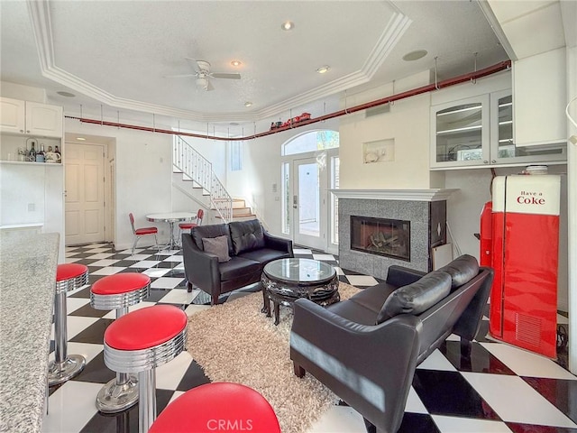 43097 Calle Camellia, Temecula, CA 92592 - living area featuring tile patterned floors, stairway, ornamental molding, a ceiling fan, and a raised ceiling
