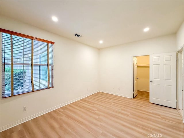 43097 Calle Camellia, Temecula, CA 92592 - unfurnished bedroom with light wood-type flooring, recessed lighting, a walk in closet, and a closet