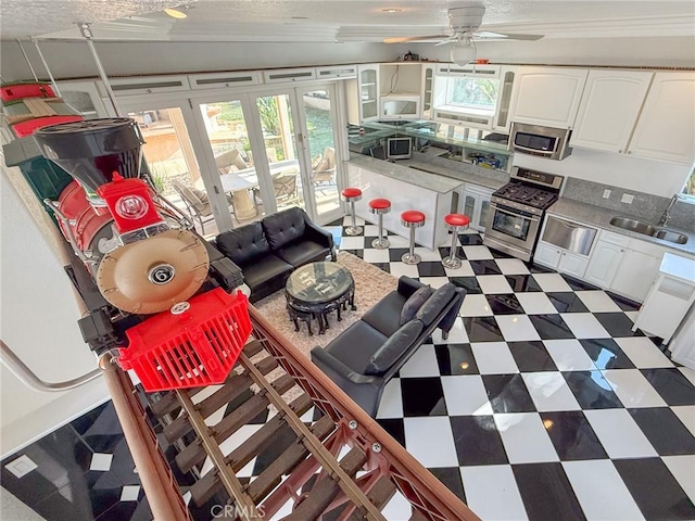 43097 Calle Camellia, Temecula, CA 92592 - living room with tile patterned floors, a ceiling fan, and a textured ceiling