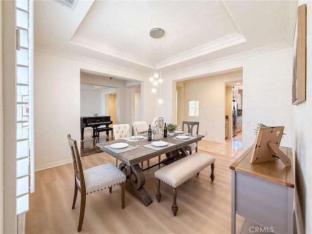 43097 Calle Camellia, Temecula, CA 92592 - dining space featuring a tray ceiling, light wood finished floors, and crown molding