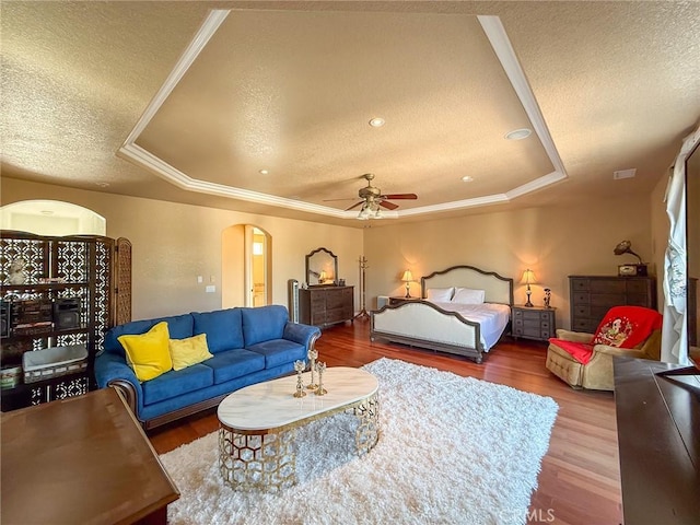 43097 Calle Camellia, Temecula, CA 92592 - bedroom with a textured ceiling, arched walkways, wood finished floors, a tray ceiling, and crown molding