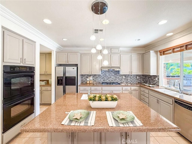 43097 Calle Camellia, Temecula, CA 92592 - kitchen featuring appliances with stainless steel finishes, an island with sink, decorative light fixtures, decorative backsplash, and ornamental molding