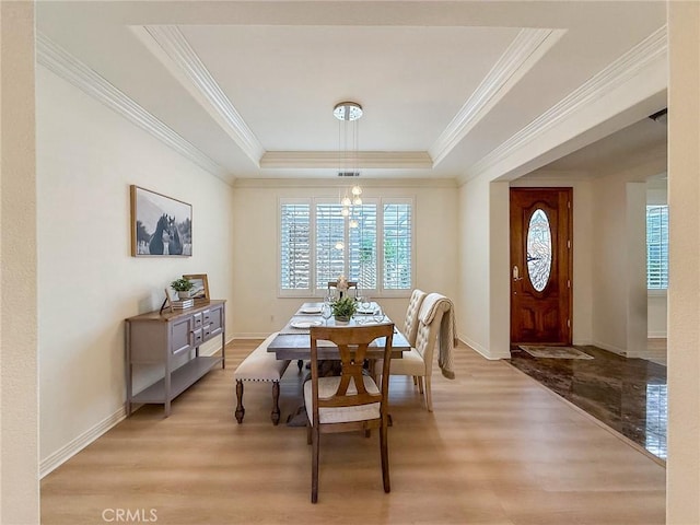 43097 Calle Camellia, Temecula, CA 92592 - dining space featuring a raised ceiling, ornamental molding, and light wood-type flooring