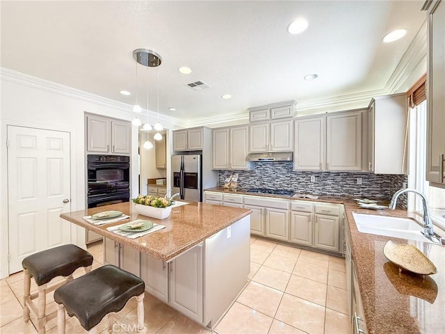43097 Calle Camellia, Temecula, CA 92592 - kitchen featuring stainless steel appliances, a kitchen bar, backsplash, light stone countertops, and decorative light fixtures