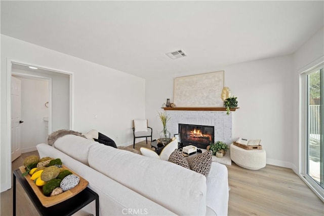 2143 Westminster Dr, Palmdale, CA 93550 - living room featuring a fireplace and light wood-type flooring