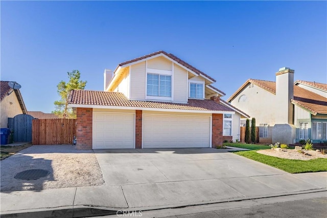 2143 Westminster Dr, Palmdale, CA 93550 - traditional-style house with a tile roof, a gate, concrete driveway, and brick siding
