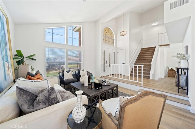 2143 Westminster Dr, Palmdale, CA 93550 - living area with wood finished floors, stairway, and a high ceiling