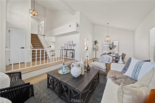 2143 Westminster Dr, Palmdale, CA 93550 - living room featuring a chandelier, high vaulted ceiling, stairway, plenty of natural light, and wood finished floors