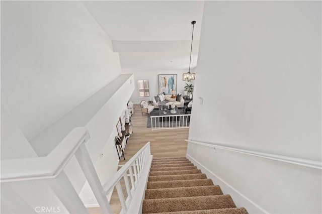 2143 Westminster Dr, Palmdale, CA 93550 - staircase featuring wood finished floors and a chandelier