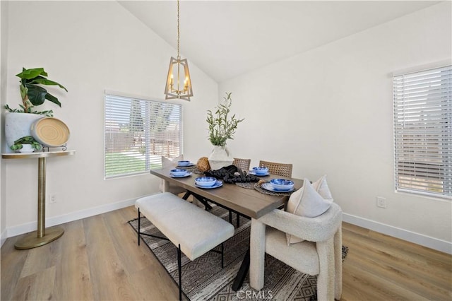 2143 Westminster Dr, Palmdale, CA 93550 - dining room with a chandelier, vaulted ceiling, and light wood-style floors